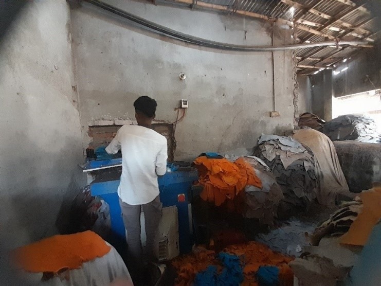 Sonju operating a machine in his factory