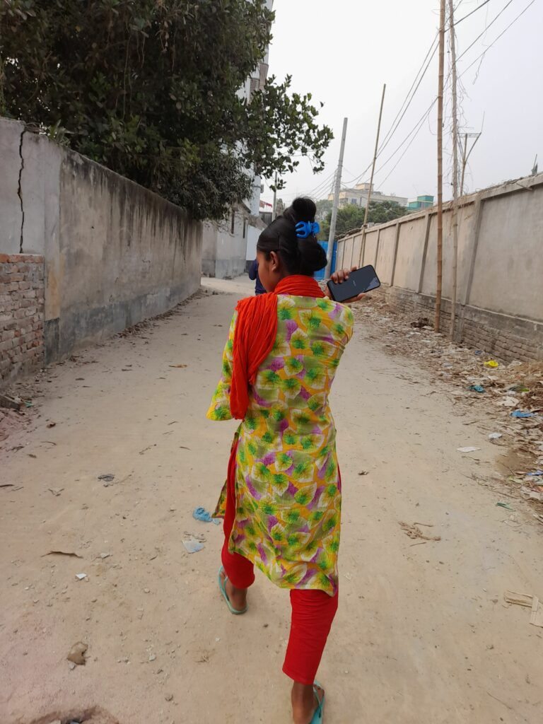 Jhilik walking near her home