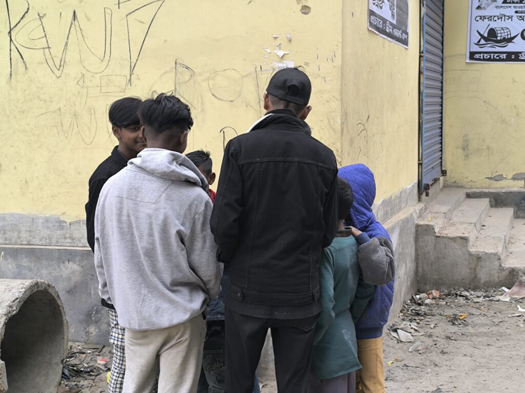 Group of teenage boys in huddle chatting