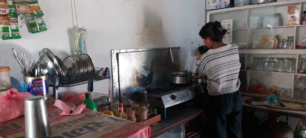 Child making tea in a khaja ghar