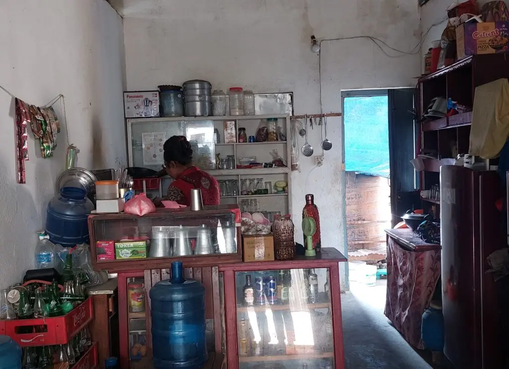 Interior of khaja ghar and child in kitchen with owner