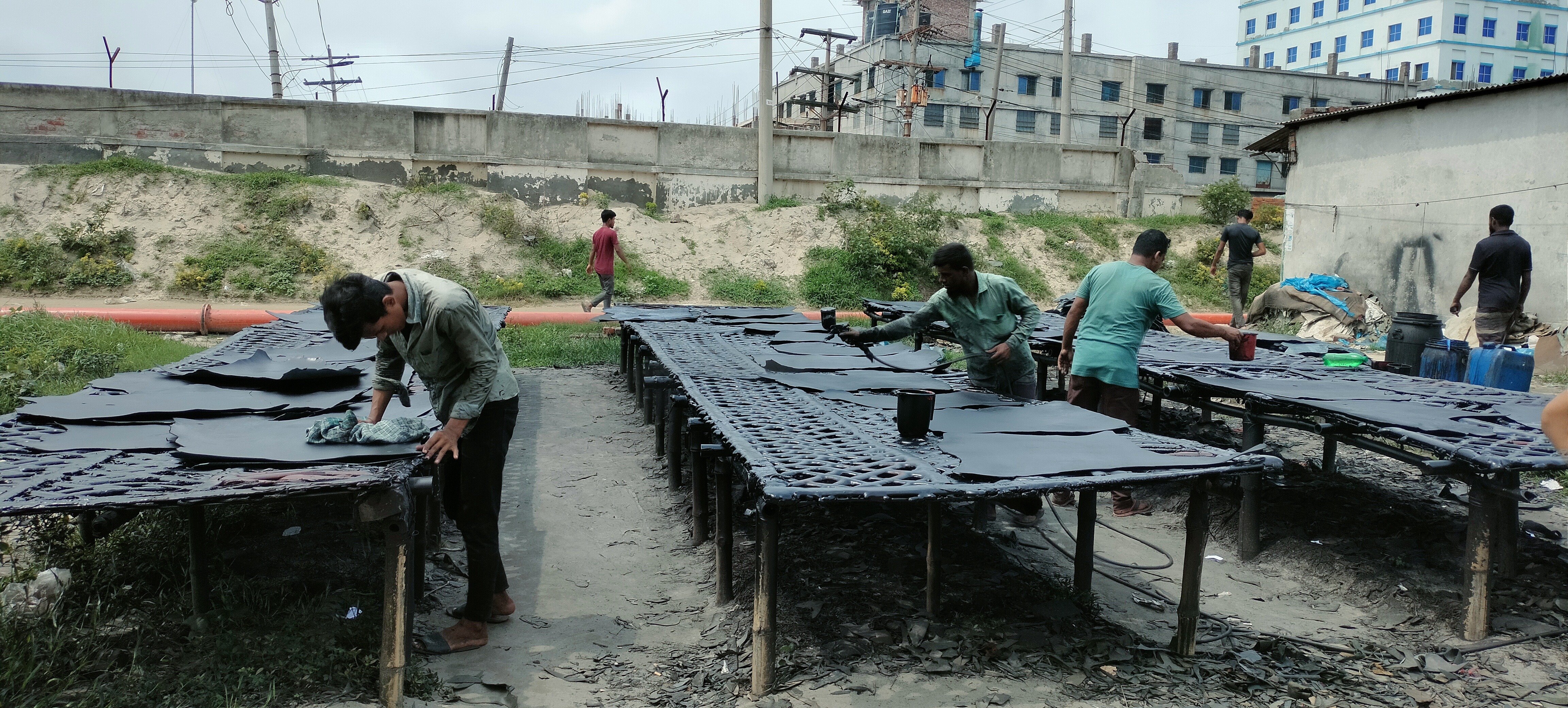 Workers dyeing leather by hand on land rented by Jahangir for BDT 19,900 (US $181) a year