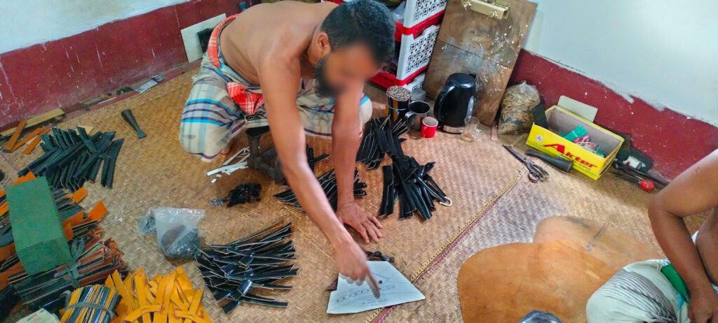 The business owner is cutting different parts of shoes according to the design