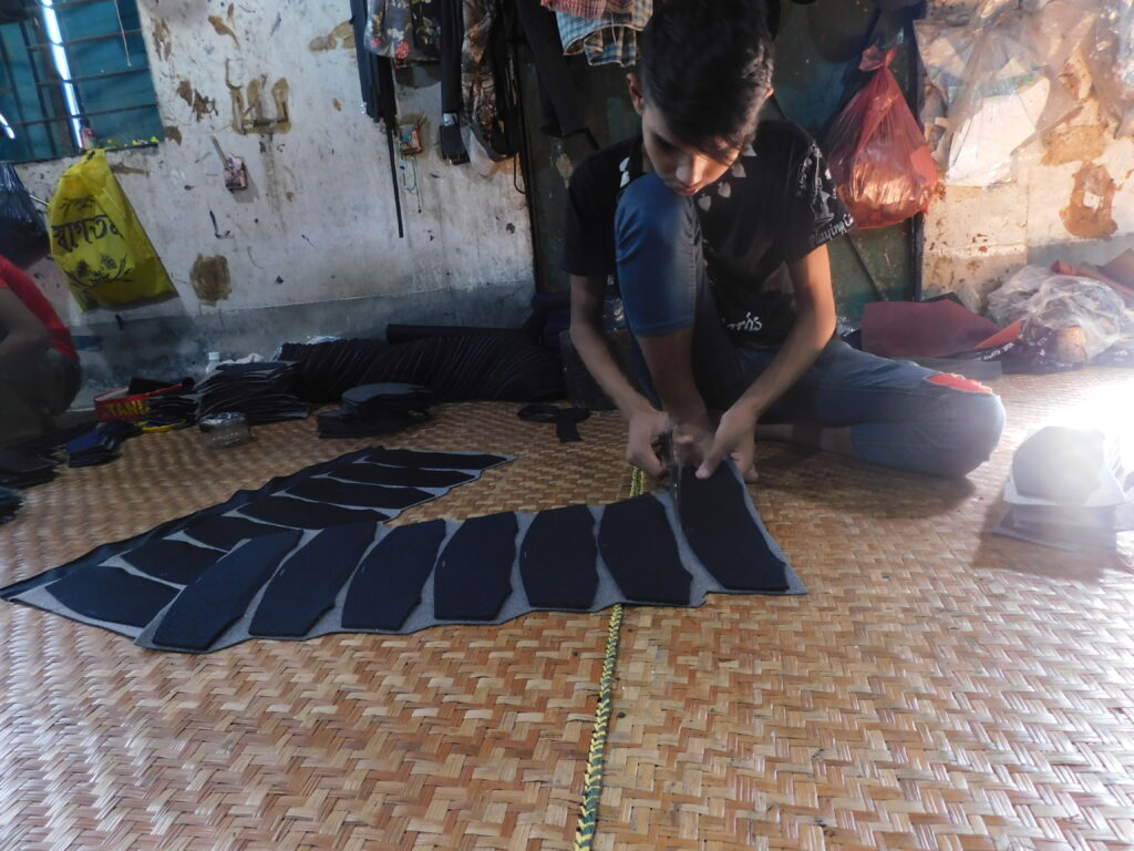 A child cutting leather